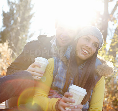 Buy stock photo Happy couple, coffee and hug on nature date for romance, bonding and outdoor park for commitment. People, woods and hot chocolate to relax in winter season for love, espresso and embrace for security