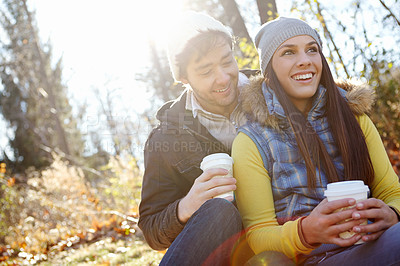 Buy stock photo Couple, coffee and hug on nature date for romance, bonding and outdoor park for commitment. People, woods and hot chocolate to relax in winter season for love, espresso and embrace for security