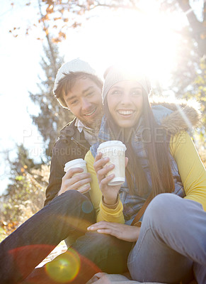 Buy stock photo Couple, happy and relax with coffee in nature for bonding, picnic and winter adventure with lens flare. People, smile and caffeine drink in forest on holiday, vacation or together in woods for travel