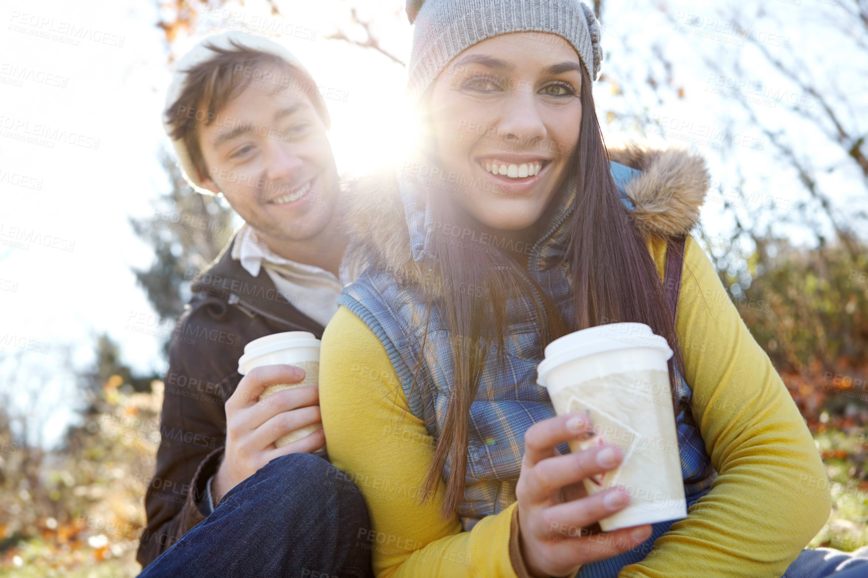 Buy stock photo Couple, portrait and relax with coffee in nature for bonding, picnic or winter adventure with lens flare. People, smile and caffeine cup in forest on holiday, vacation or together in woods for travel