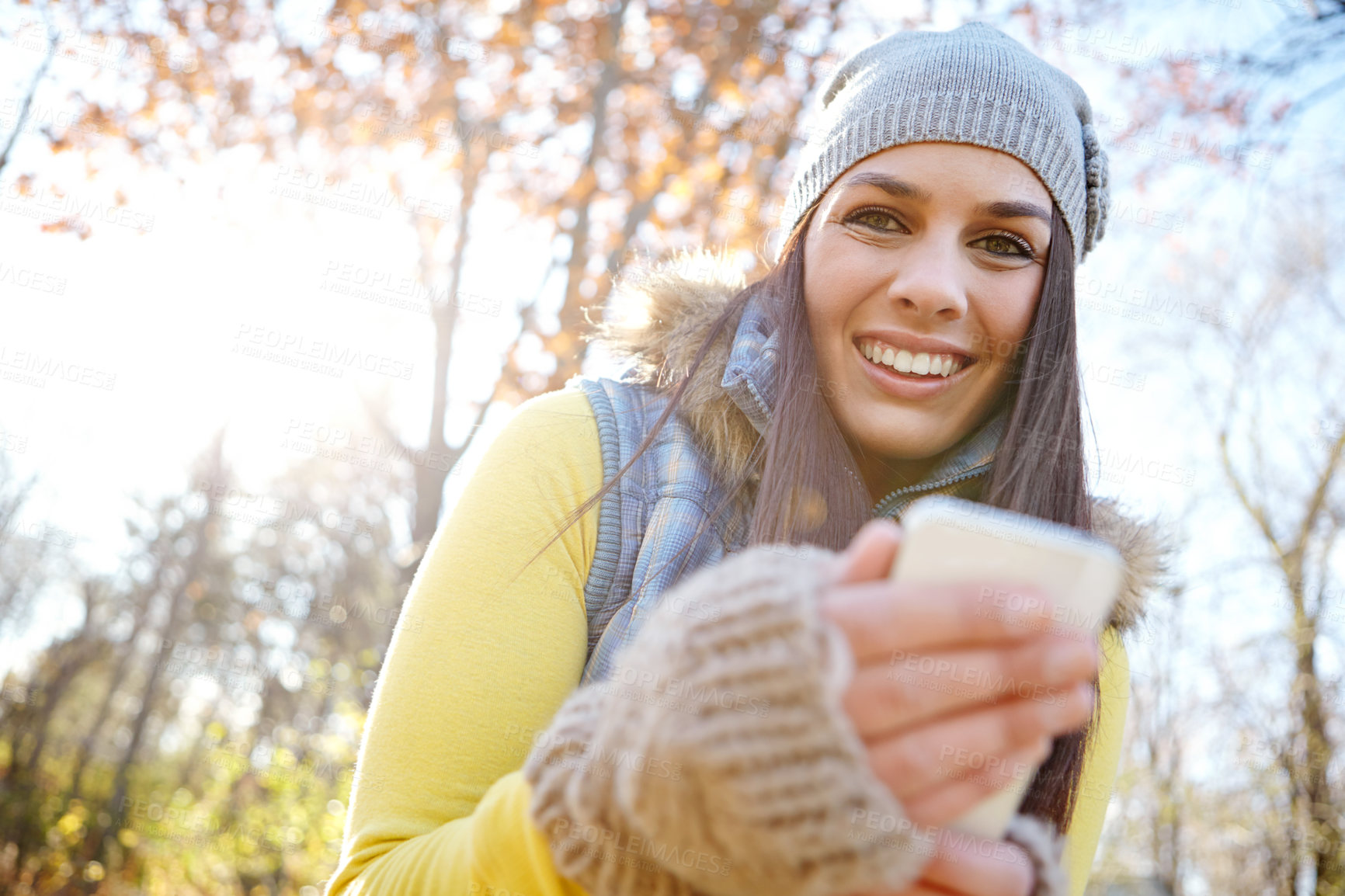 Buy stock photo Woman, smartphone and autumn portrait or happy, reading and message on mobile app for communication. Smile, internet and online or ecommerce, blog and social media in nature for connection browsing