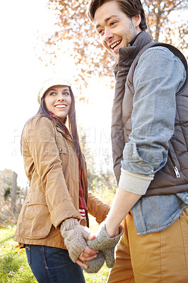 Buy stock photo Couple, winter and holding hands in forest for outdoor date with love, warm clothes and security. Happy man, woman and walk in nature with fashion for cold climate, bonding and palm touch for loyalty