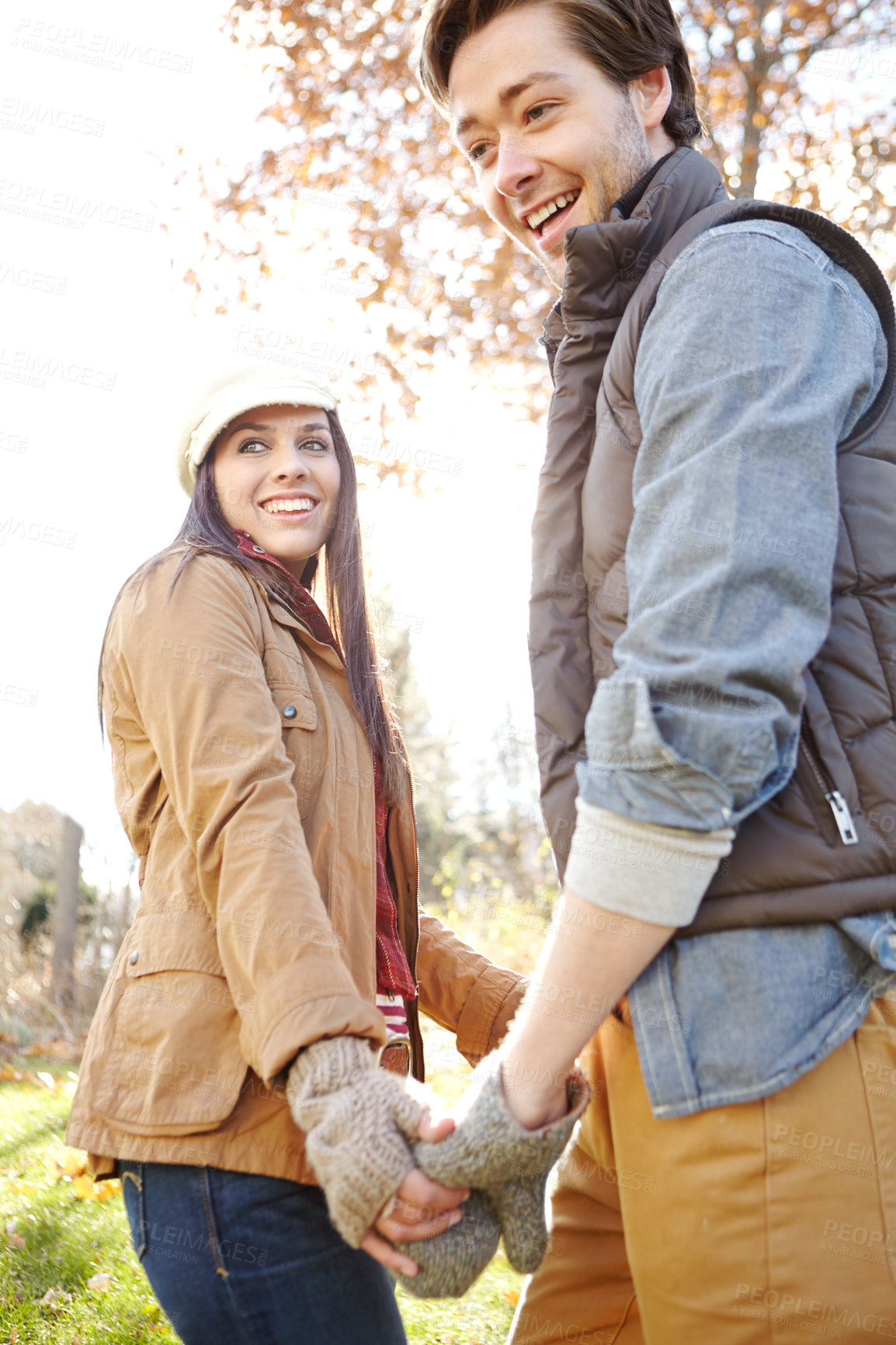 Buy stock photo Couple, winter and holding hands in forest for outdoor date with love, warm clothes and security. Happy man, woman and walk in nature with fashion for cold climate, bonding and palm touch for loyalty