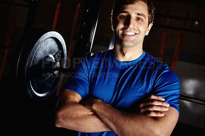 Buy stock photo Man, happy and confidence in gym for fitness with smith machine for squats and muscle development. Athlete, smile and crossed arms in portrait with barbell weights for exercise, health and wellness