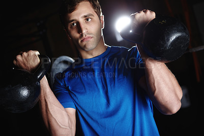 Buy stock photo Man, gym and kettlebell for training or fitness for balance, coordination and muscle toning in arms. Male person, weights and physical cardio for cardiovascular health, endurance and core strength.