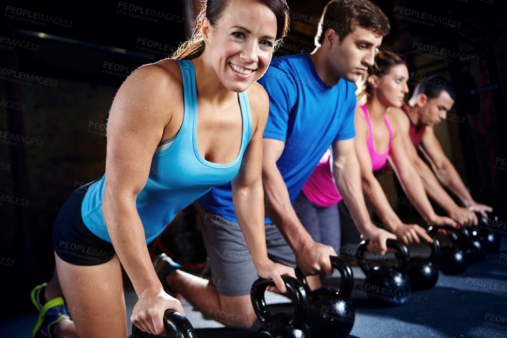 Buy stock photo Push up, gym and portrait of woman with dumbbells, smile and commitment to body workout together. Bodybuilder, group and people in exercise class with kettlebell, power fitness training and teamwork