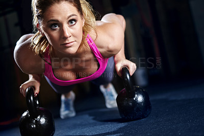 Buy stock photo Woman, athlete and kettlebell in pushups, fitness center or exercise for health, strong muscle or wellness. Female person, sport and gym for weight training, cardio or bodybuilder in workout routine