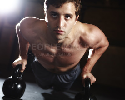 Buy stock photo Man, athlete and kettlebell in pushups, fitness center and exercise for health, strong muscle and wellness. Male person, sports and gym for weight training, cardio and bodybuilder in workout routine