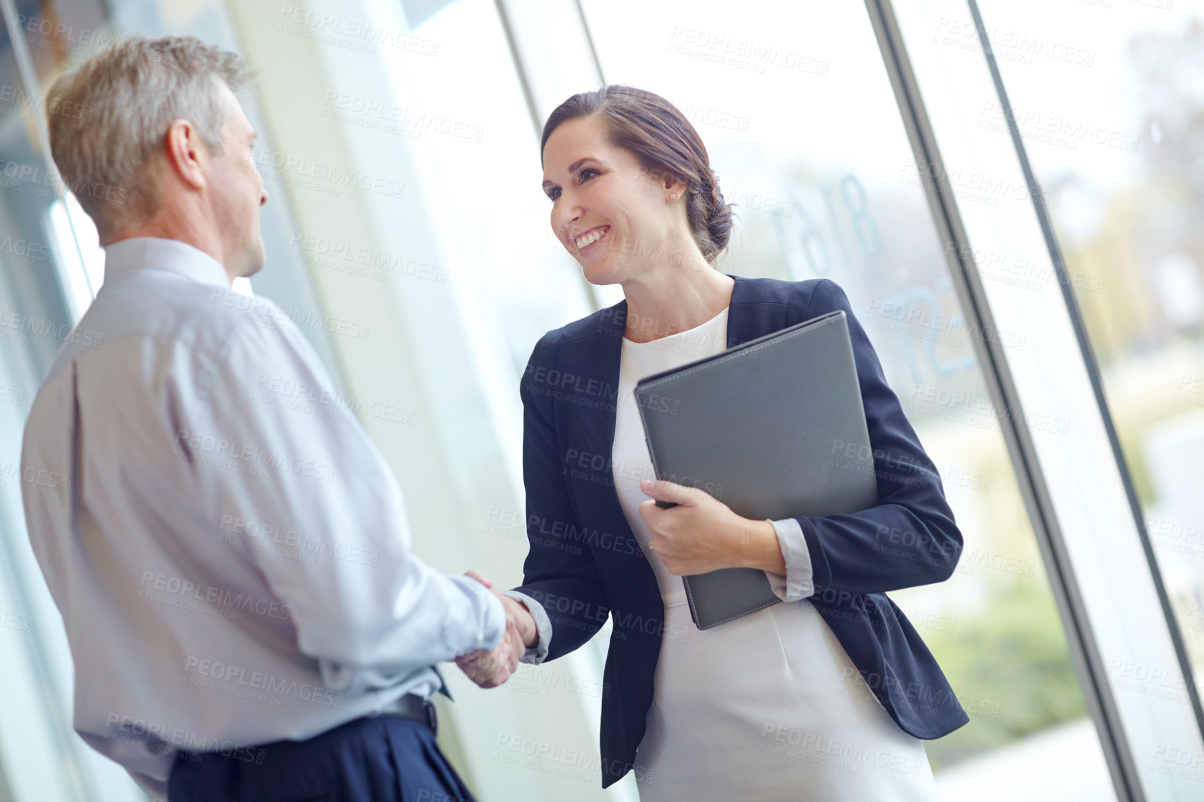 Buy stock photo Handshake, laptop and smile with business people in office together for hiring or onboarding. Computer, interview or welcome with happy employee and mentor shaking hands in workplace for agreement