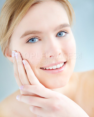 Buy stock photo Portrait, relax and happy woman in studio for beauty or treatment for facial glow, shine or wellness. Dermatology, hands or girl with face routine for cosmetics or natural skincare by blue background