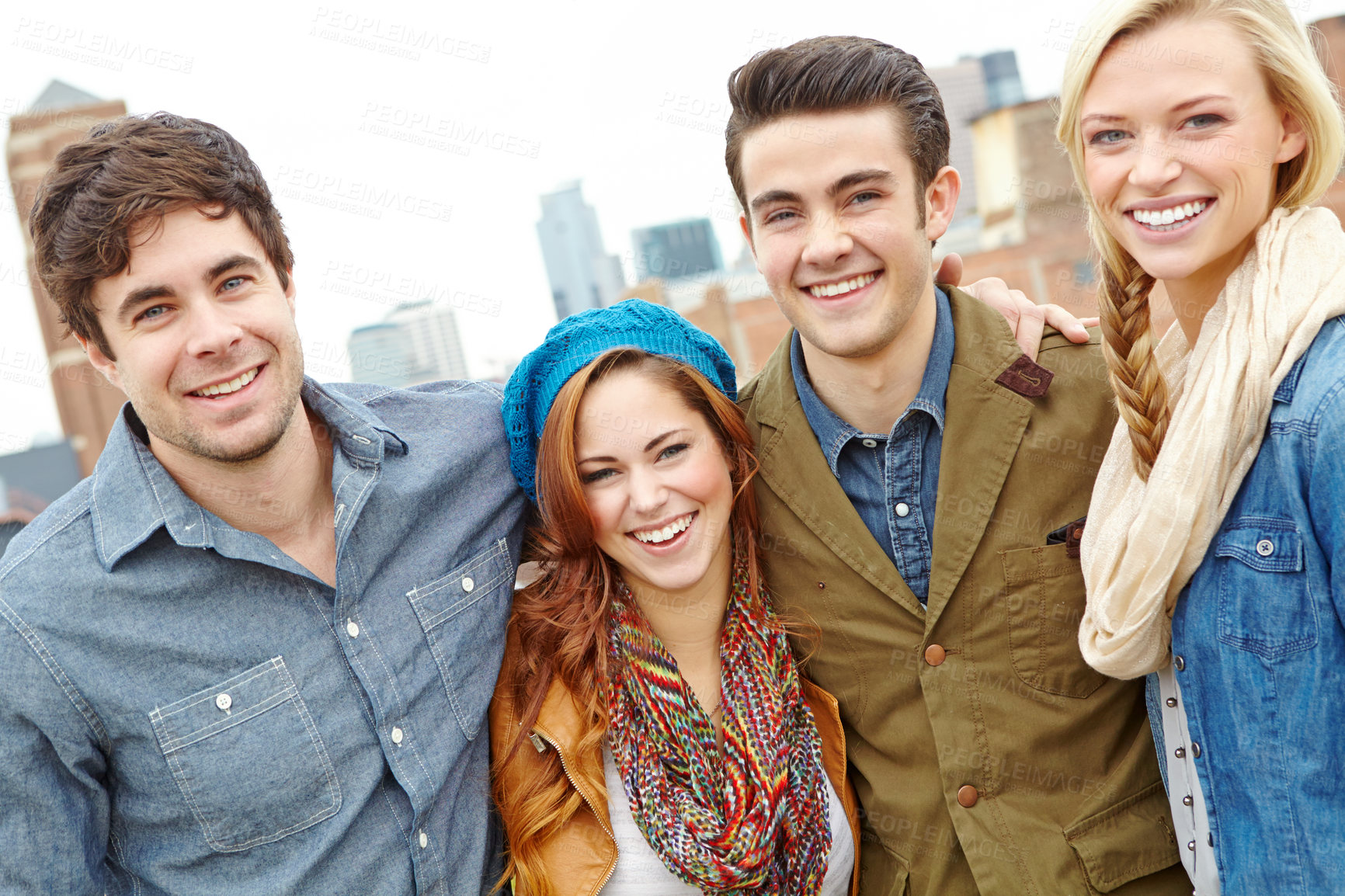 Buy stock photo Two young couples standing together against a cityscape