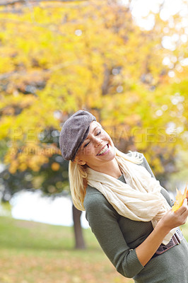 Buy stock photo Fashion, happy and woman with leaf in nature for Autumn weather on holiday, getaway or vacation. Smile, outdoor and female person from Denmark with stylish outfit in park or field on weekend trip.