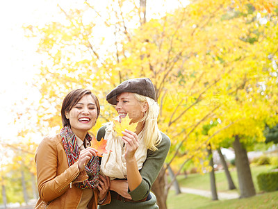 Buy stock photo Smile, friends and women with leaves in autumn for outdoor environment, adventure and season change. People, happy and relax with foliage in park for travel, vacation and holiday together in Germany