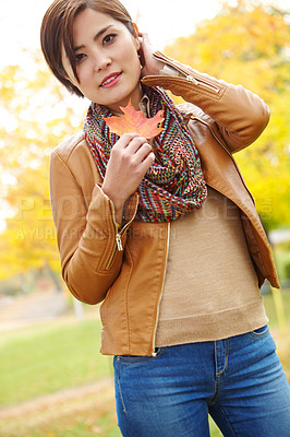 Buy stock photo Woman, autumn and portrait with leaf in environment with smile, sustainability and adventure in nature. Korean person, face and travel with plant foliage in outdoor park with relax, happy and holiday