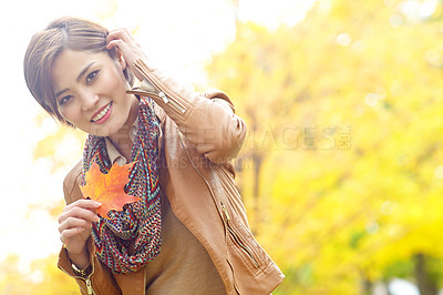 Buy stock photo Woman, autumn and portrait with leaves in nature with smile, sustainability or adventure in park. Korean person, face and travel with plant foliage in outdoor environment with relax, space or holiday