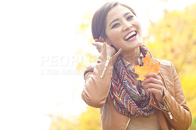 Buy stock photo Asian woman, portrait and leaf in park during autumn season for leisure, joy and fun outdoor on holiday. Female person, face and trees in nature in fall weather for travel, vacation and positive mood