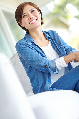 Buy stock photo An attractive Asian woman wearing a casual denim shirt relaxing at home