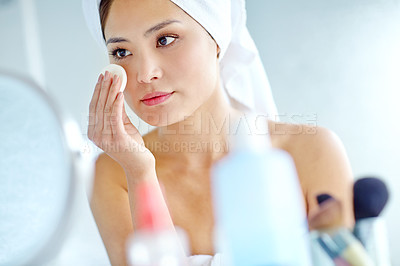 Buy stock photo Woman, towel and cotton pad for skincare, toner and makeup remover in house with mirror after shower. Asian person, face and beauty routine in home for cleaning, serum application and healthy skin