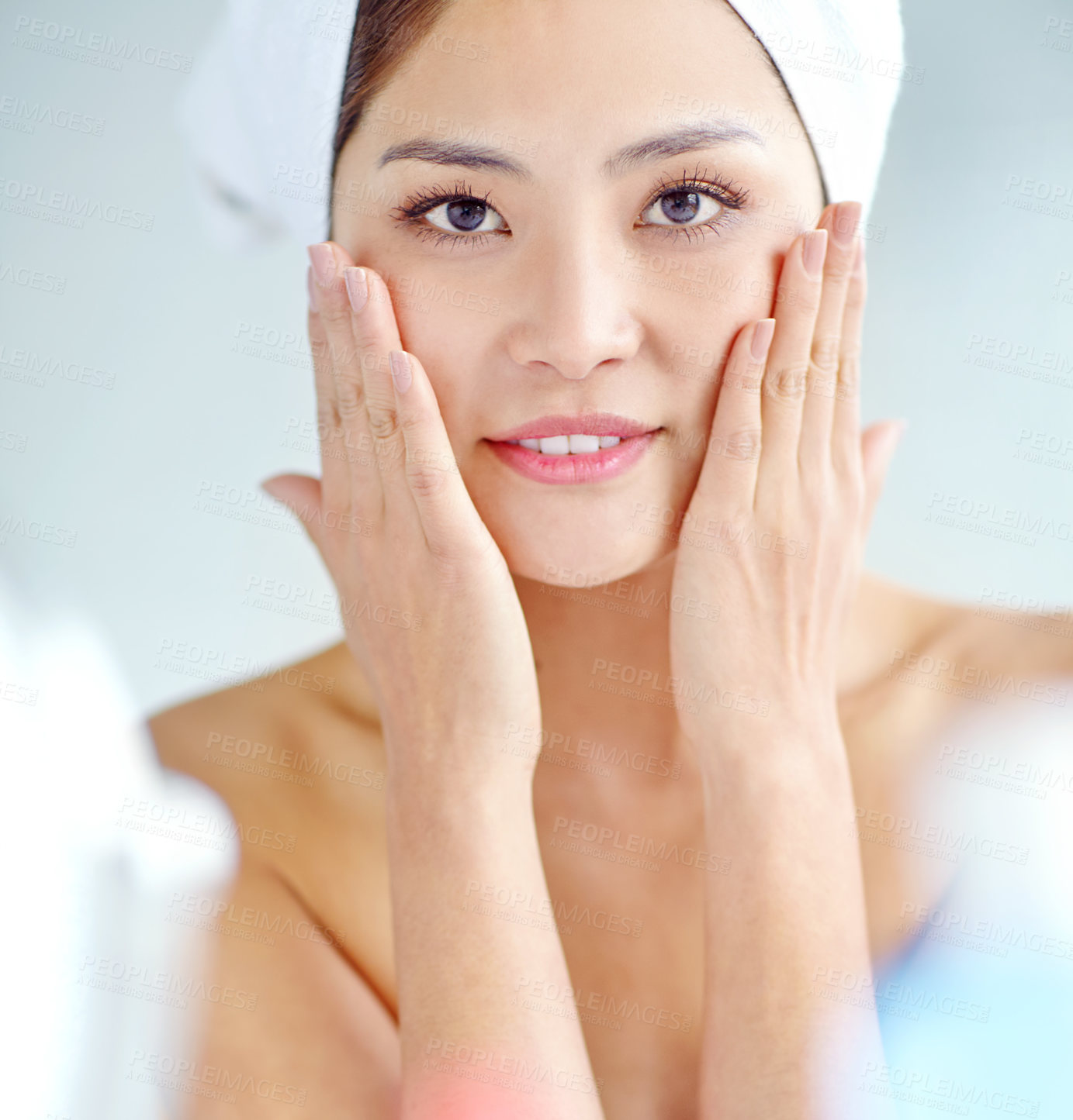 Buy stock photo Asian woman, bathroom and beauty with hands on face for moisturizer, portrait and benefits in home. Person, towel and grooming routine with cosmetics, happy and results with skincare in morning