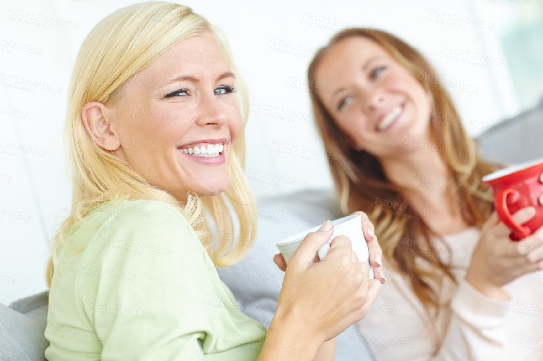 Buy stock photo Coffee, friends and portrait of women on sofa laughing for bonding, conversation and relationship. Happy, home and people relax with drink, tea and mug in living room for talk, chat and social visit