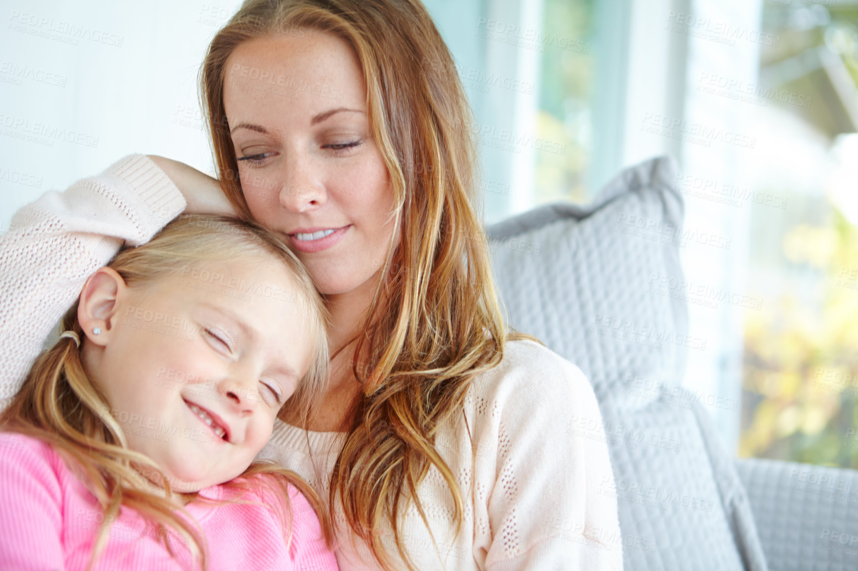 Buy stock photo Relax, woman and smile with hug of kid for weekend, appreciation or gratitude in motherhood. Home, happy and girl with cuddle of mom on sofa for family love, safety or connection in child development