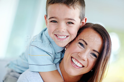 Buy stock photo Mother, child and hug on couch for love, support or care with bonding for happy childhood or weekend together at home. Portrait, mom and kid or son with smile for embrace or relax on living room sofa