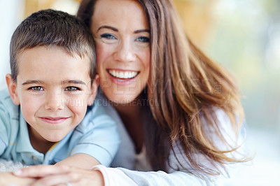 Buy stock photo Mom, child and hug for love, support or care with bonding for happy childhood or weekend together at home. Portrait, mother and kid or son with smile for embrace or relax on living room floor