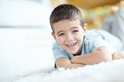 Buy stock photo Home, relax and portrait of child on carpet for weekend enjoyment, break and satisfaction. Happy, boy and face of kid by mat on floor of house for development, wellness and peace with fun in morning