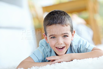 Buy stock photo Home, happy and portrait of child on carpet for weekend enjoyment, break and satisfaction. Boy, relax and face of kid by mat on floor of house for development, wellness and fun with peace in morning