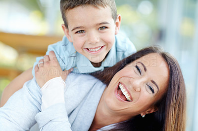 Buy stock photo Happy, piggyback and mother with child for relax, bonding or playing together on floor at home. Portrait, laugh and mom carry boy kid for fun, connection and love on carpet at family house together.