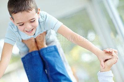 Buy stock photo Smile, parent and lifting child in home with feet for game, balance and family bonding together for support. Happy kid, playing and flying with babysitter in air, holding hands and young boy laughing