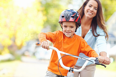 Buy stock photo Bike, learning and portrait of boy with mother outdoor on street of neighborhood for child development. Happy, love or smile with single parent woman teaching son how to ride bicycle in summer