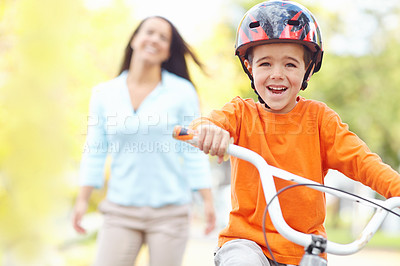 Buy stock photo Bike, learning and smile of boy with mother outdoor on street of neighborhood for child development. Happy, laughing or love with single parent woman teaching son how to ride bicycle in summer