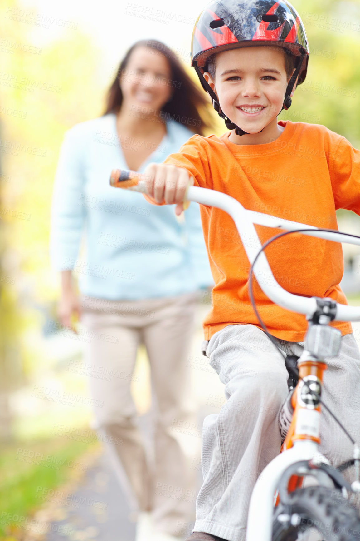 Buy stock photo Bike, learning and portrait of son with mom outdoor on street of neighborhood for child development. Happy, family or smile with single parent woman teaching boy how to balance or ride bicycle