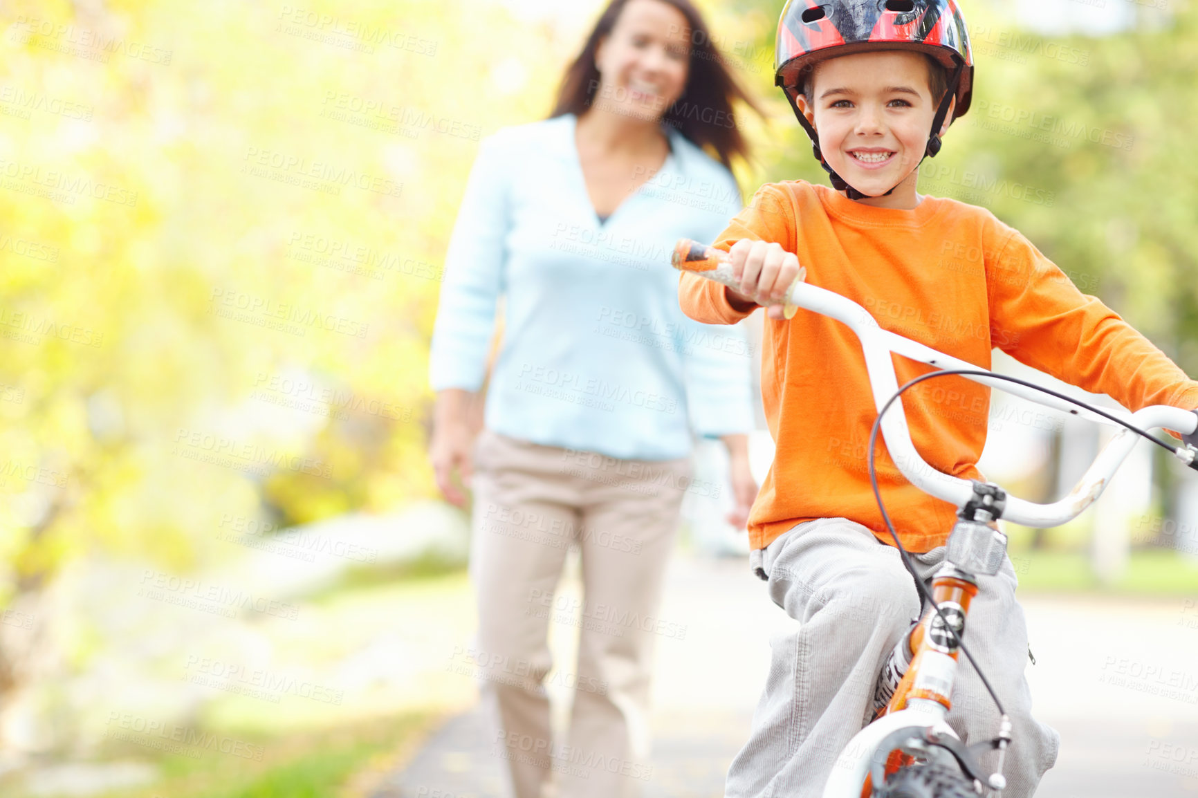 Buy stock photo Bicycle, learning and portrait of son with mom outdoor on street of neighborhood for child development. Balance, happy or smile with single parent woman teaching boy how to ride bike in summer