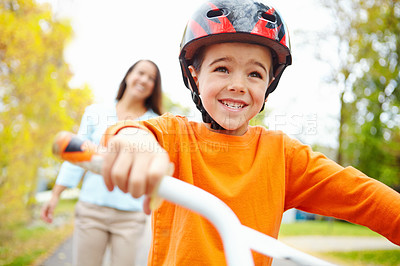 Buy stock photo Bike, excitement for learning and boy with mother outdoor on street of neighborhood for child development. Fast, happy or smile with single parent woman teaching son how to ride bicycle in summer