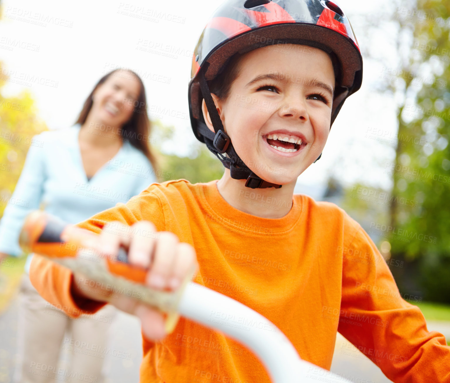 Buy stock photo Bike, learning and funny boy with mother outdoor on street of neighborhood for child development. Happy, laughing or smile with single parent woman teaching excited son how to ride bicycle in summer