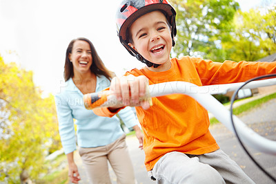 Buy stock photo Bike, learning and portrait of happy boy with mother outdoor on street of neighborhood for child development. Funny, love or smile with single parent woman teaching son how to ride bicycle in summer