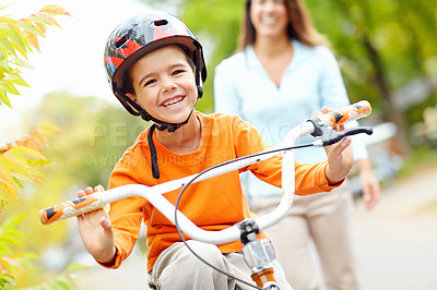 Buy stock photo Bike, learning and portrait of happy boy with mom outdoor on street of neighborhood for child development. Laughing, love or smile with single parent woman teaching son how to ride bicycle in summer