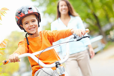 Buy stock photo Cycling, learning and portrait of boy with mother outdoor on street of neighborhood for child development. Happy, safety or smile with single parent woman teaching son how to ride bike in summer