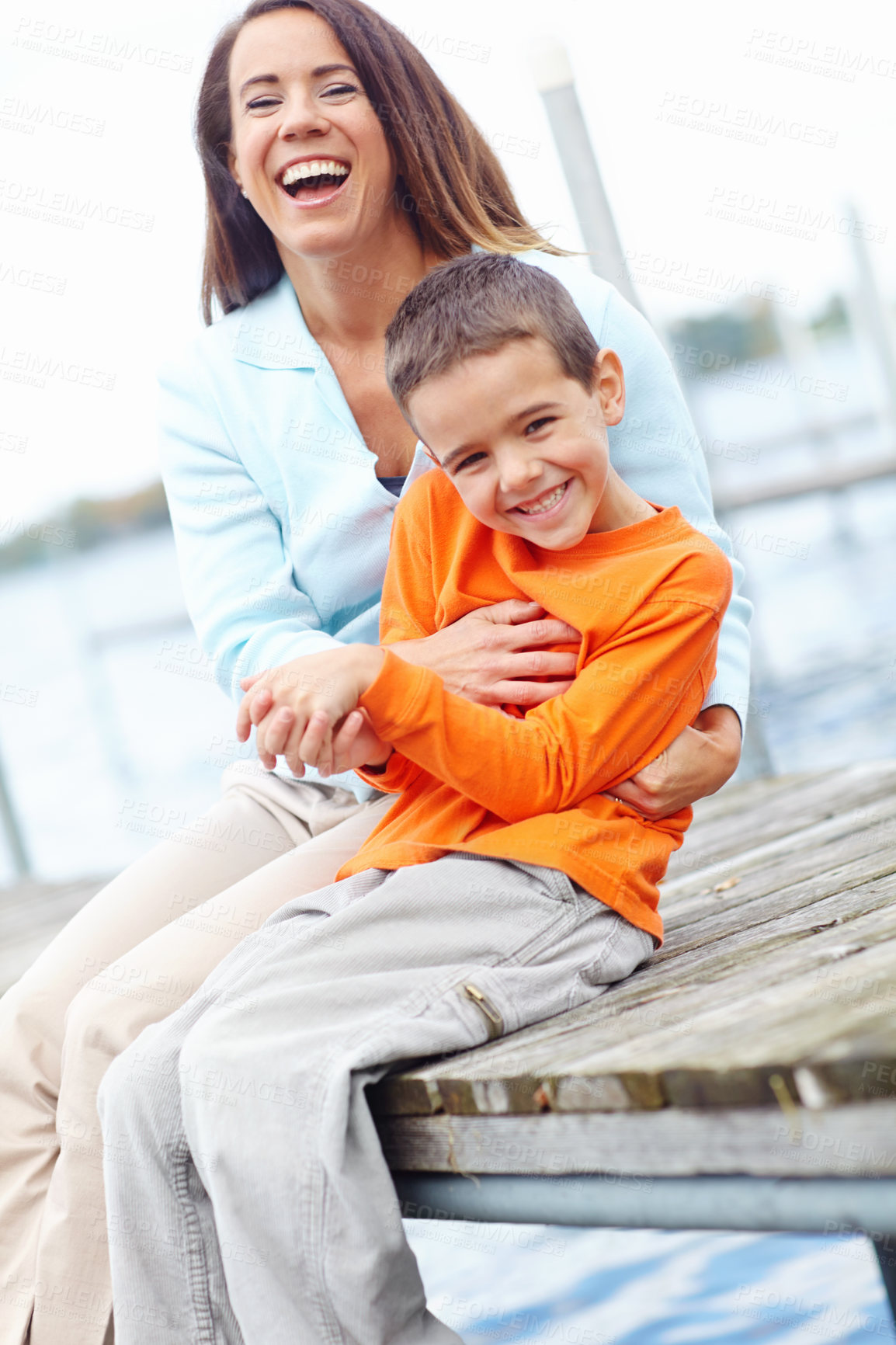 Buy stock photo Happy, mother and child on dock for portrait, love and tickling on harbour on vacation. Family, mom and kid at ocean for holiday, bonding and relationship development with trust and support in Canada