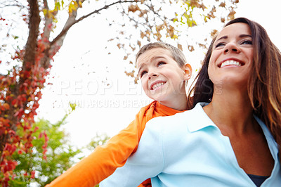 Buy stock photo Mother, boy and outdoor with smile on piggyback for fun with bonding, support and care in England. Low angle, parent and happy or excited with kid for child development, growth and childhood memories