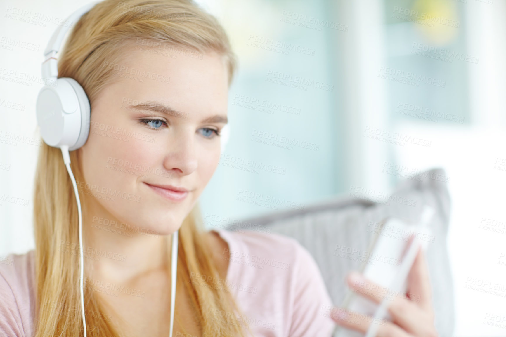 Buy stock photo Headphones, phone and woman in home listening to music, song or radio on sofa in living room. Smile, cellphone and female freelance playlist curator with audio tech for online album review at house.