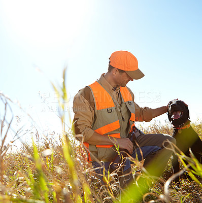 Buy stock photo Man, stroke dog and outdoor for hunting season, bush and search for prey together in nature. Person, pet animal and hunter helper in field to guide in woods, affection and tracking in sports