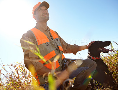 Buy stock photo Man, dog and outdoor for hunting season, stroke and search for prey together in nature. Mature person, pet animal and hunter helper in field to guide in woods, partnership and tracking in sports