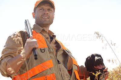 Buy stock photo A man out hunting with his retriever dog beside him