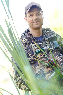 Buy stock photo A hunter wearing camo attire in the reeds on a hunt
