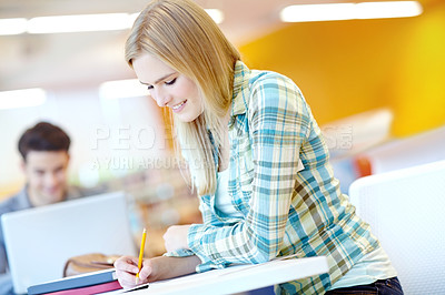 Buy stock photo Student, reading and writing in notebook or classroom for study group, project or assignment. Female person, happiness and research for education, course and learning in college, campus or university