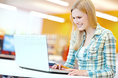 Buy stock photo Girl, college student and reading with laptop for studying at library, learning and education. Person, woman and computer at university, scroll and happy for info, scholarship and research in Germany