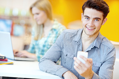 Buy stock photo Education, phone and portrait of student man in library at college or university campus for learning. Development, social media and study with happy person at school desk or table for scholarship